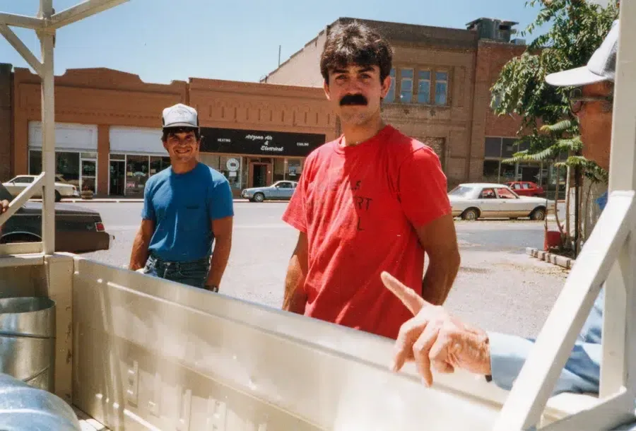 Goettl’s High Desert Mechanical technician carrying HVAC panel outside commercial site – Prescott Valley AZ
