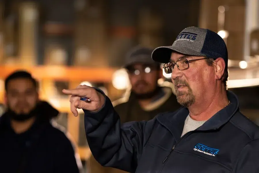 Lead technician giving instructions during training or team workshop – Goettl’s High Desert Mechanical Prescott Valley AZ