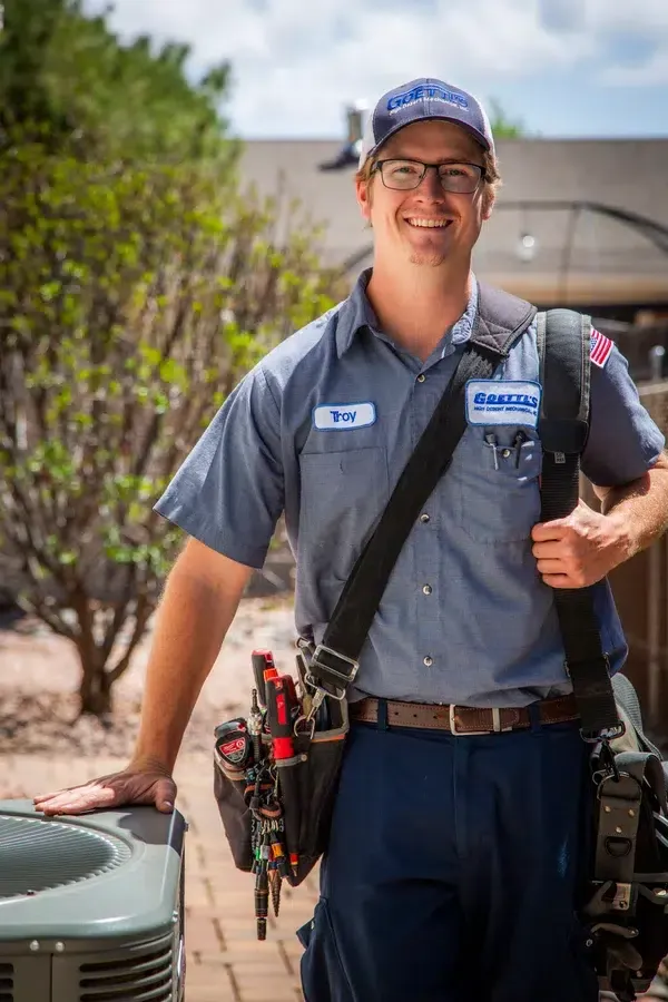 Goettl’s High Desert Mechanical technician carrying tool bag while walking toward customer’s HVAC system – Prescott Valley AZ