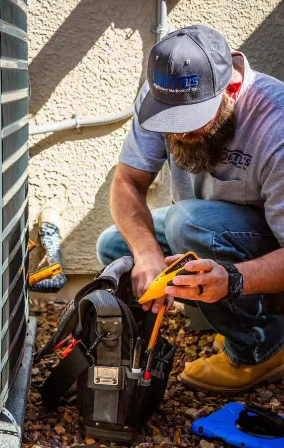 Goettl’s High Desert Mechanical technician repairing wiring at outdoor HVAC condenser – Prescott Valley AZ