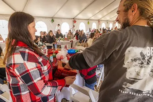 Crowd of families and team members seated under a large event tent during community celebration – Goettl’s High Desert Mechanical Prescott Valley AZ