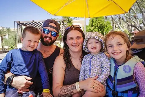 Family posing together by the pool at a summer community gathering – Goettl’s High Desert Mechanical Prescott Valley AZ