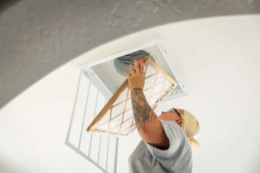 Goettl's tech installing fresh HVAC air filter in ceiling return vent – Goettl’s High Desert Mechanical Prescott Valley AZ