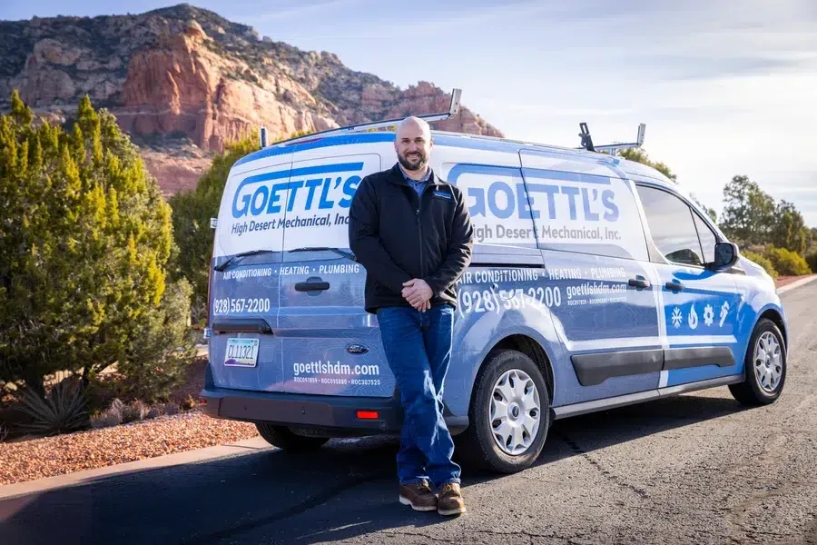 Goettl’s High Desert Mechanical technician leaning against service van in scenic Arizona landscape – Prescott Valley AZ