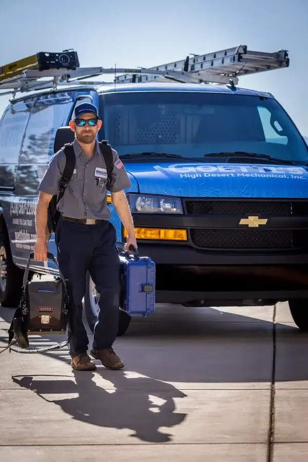 Goettl’s High Desert Mechanical technician walking toward service van carrying tools – Prescott Valley AZ