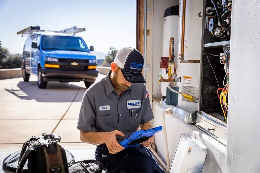 Goettl’s High Desert Mechanical technician reviewing notes on clipboard during service visit – Prescott Valley AZ