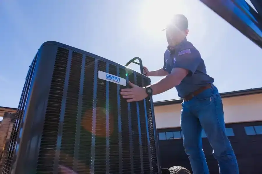 Goettl's technician servicing air conditioning unit