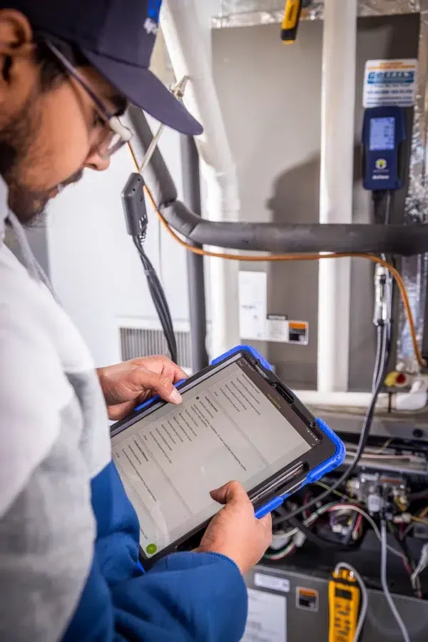 Goettl’s High Desert Mechanical technician using tablet to review system information – Prescott Valley AZ