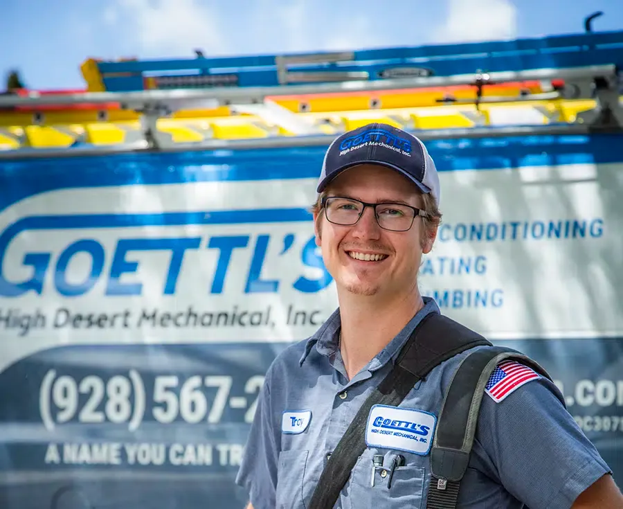 Goettl’s High Desert Mechanical technician smiling in front of service van during outdoor job – Prescott Valley AZ