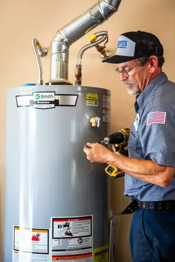 Goettl’s High Desert Mechanical technician checking water heater controls with gauge tool – Prescott Valley AZ