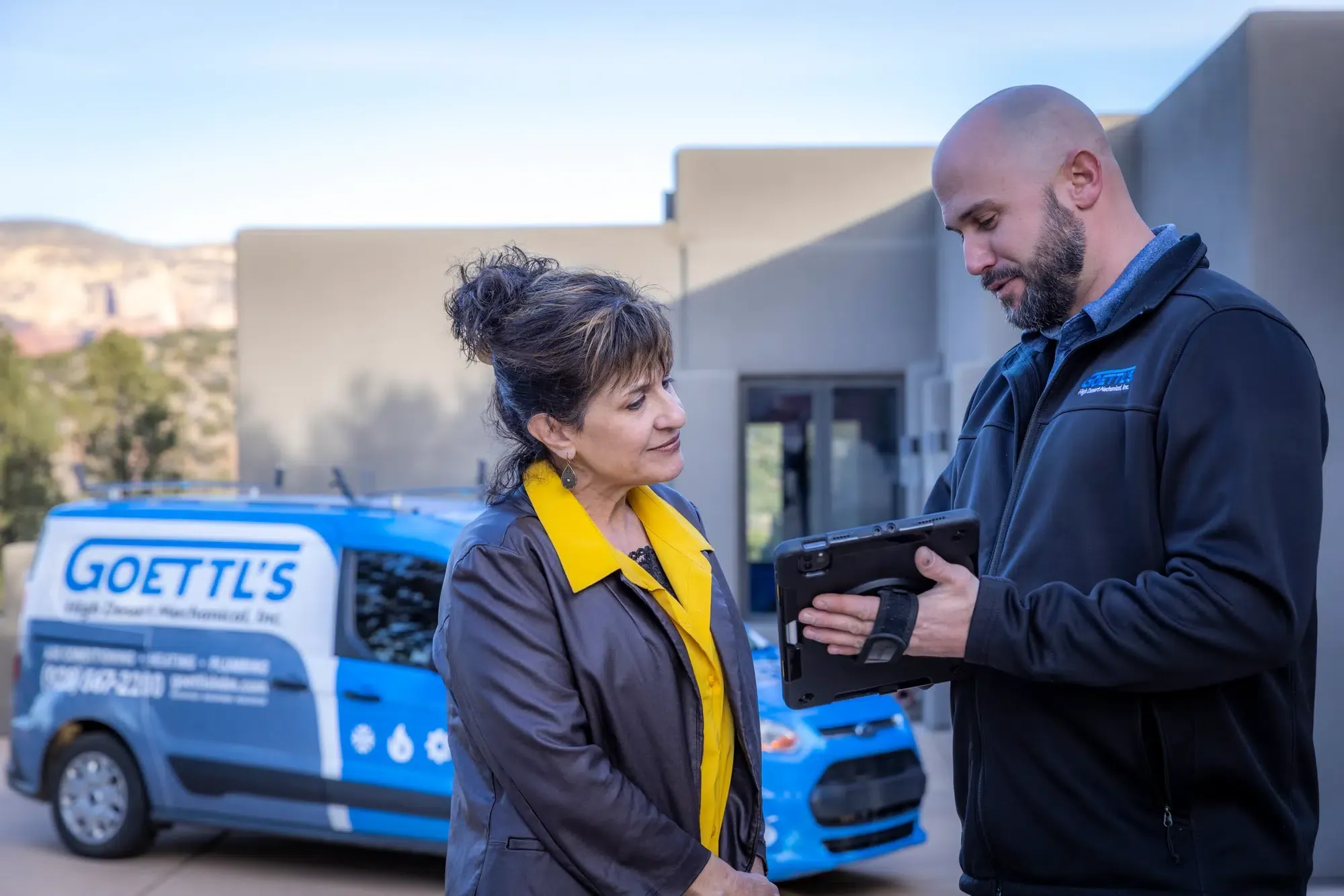 Goettl’s High Desert Mechanical technician speaking with homeowner outside during service visit – Prescott Valley AZ