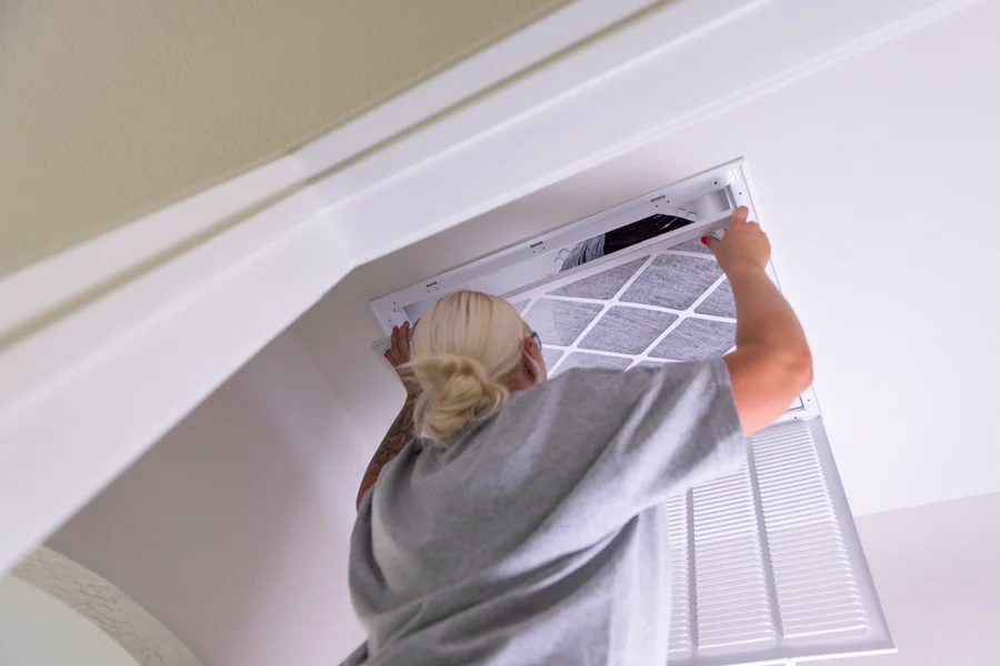 Goettl's tech installing fresh HVAC air filter in ceiling return vent – Goettl’s High Desert Mechanical Prescott Valley AZ