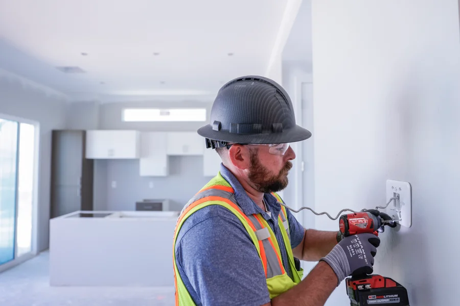 Technician using drill to install HVAC components inside home – Goettl’s High Desert Mechanical Prescott Valley AZ