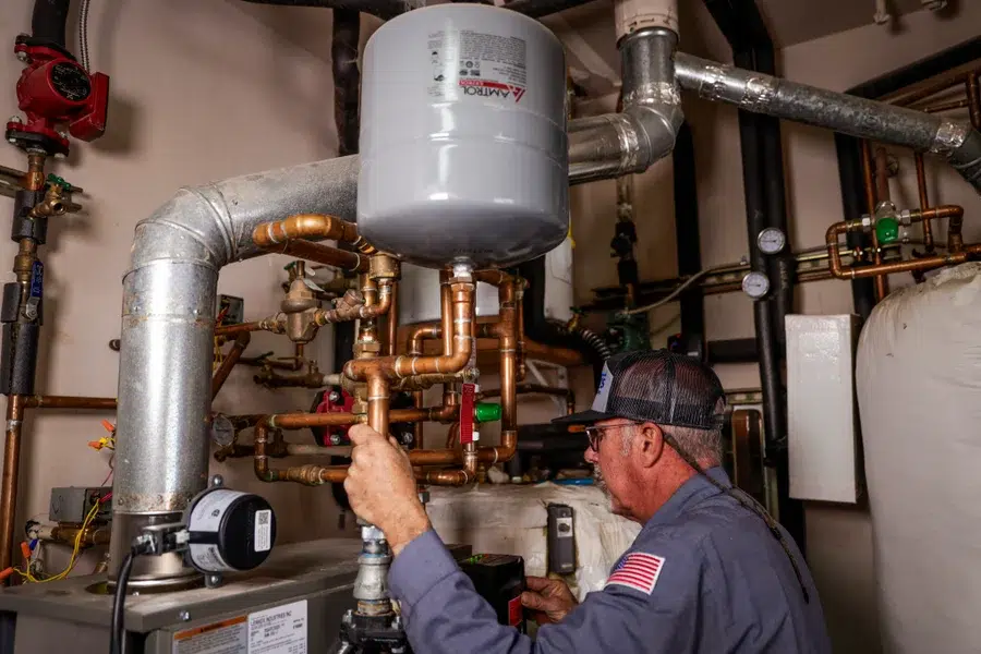 Goettl's plumber completing backflow testing & prevention in home – Prescott Valley AZ