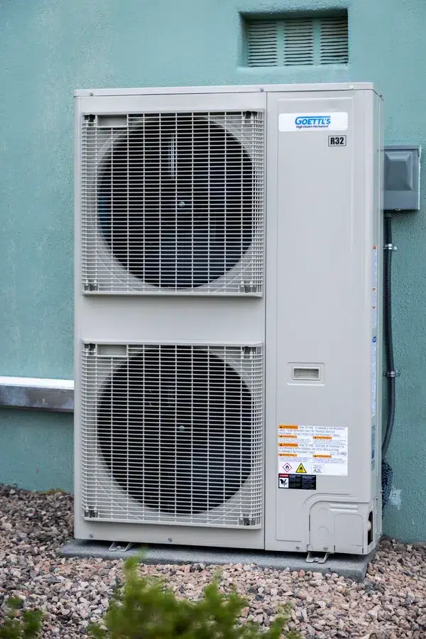 Goettl’s High Desert Mechanical outdoor condenser with dual fan system mounted on exterior wall – Prescott Valley AZ