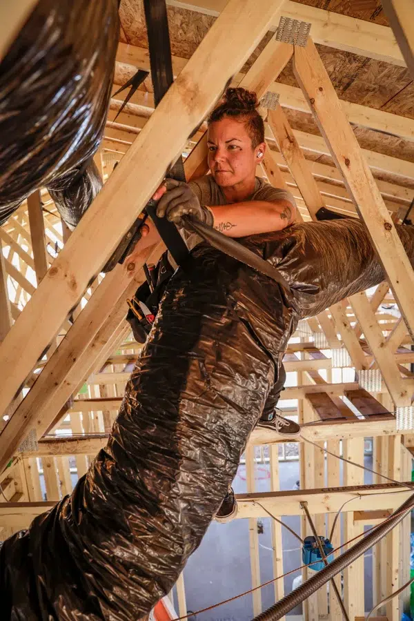 Technician installing flexible ductwork in attic framing – Goettl’s High Desert Mechanical Prescott Valley AZ