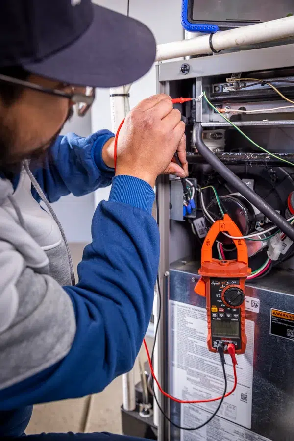Goettl’s High Desert Mechanical technician inspecting wiring inside HVAC cabinet – Prescott Valley AZ