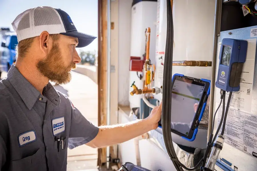 Goettl’s High Desert Mechanical technician working on wall-mounted HVAC system – Prescott Valley AZ