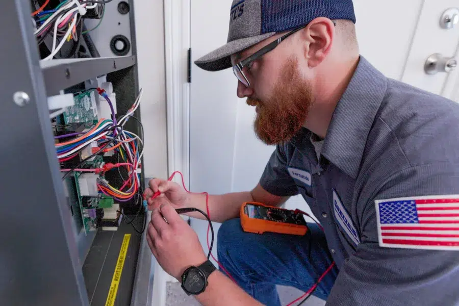 Goettl’s High Desert Mechanical technician working on heating system – Prescott Valley AZ