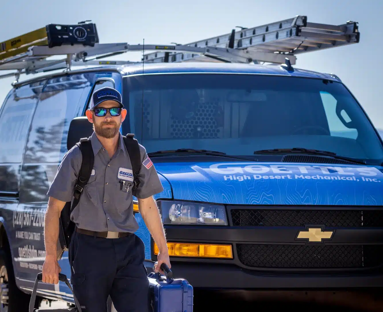 Goettl’s High Desert Mechanical technician walking toward service van carrying tools – Prescott Valley AZ