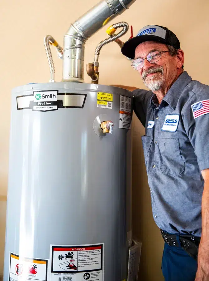 Goettl’s High Desert Mechanical technician inspecting water heater tank during service – Prescott Valley AZ